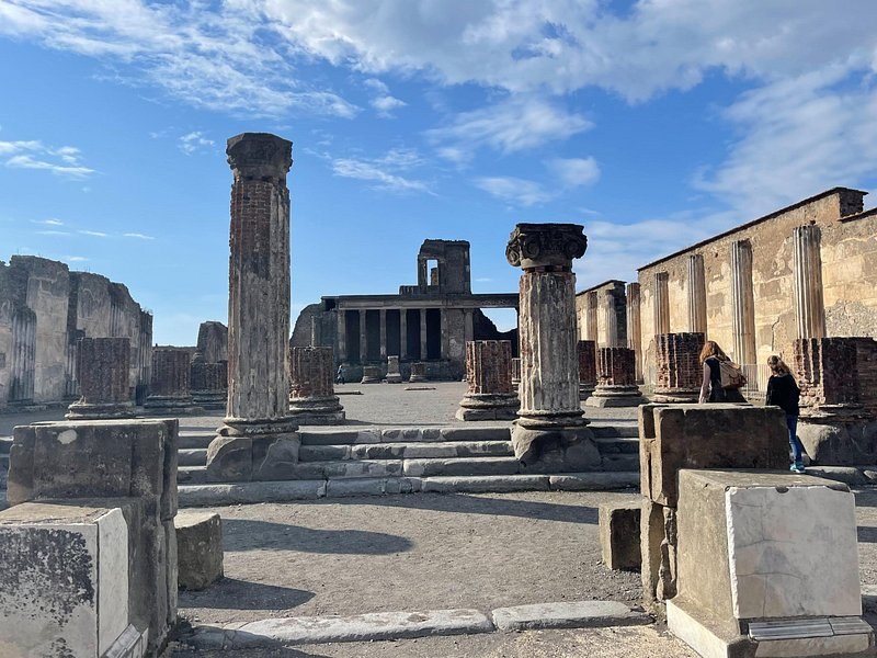The colonnade along the Forum at Pompeii under a clear morning sky