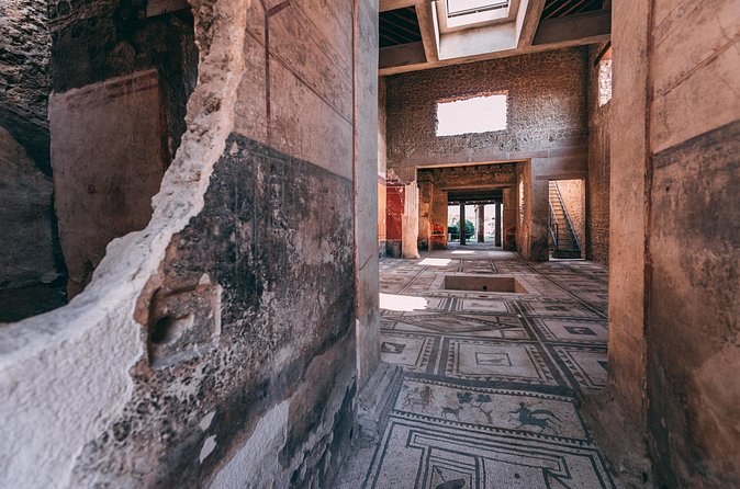 A corridor inside a house at Pompeii, its mosaic floor still in place