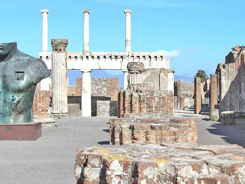 A sculpted torso on a plinth among the Forum columns at Pompeii