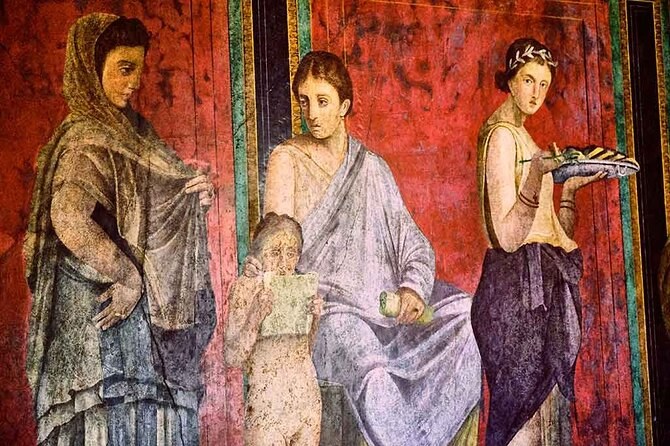 A detail of the Villa of the Mysteries frieze at Pompeii, three figures and a tray
